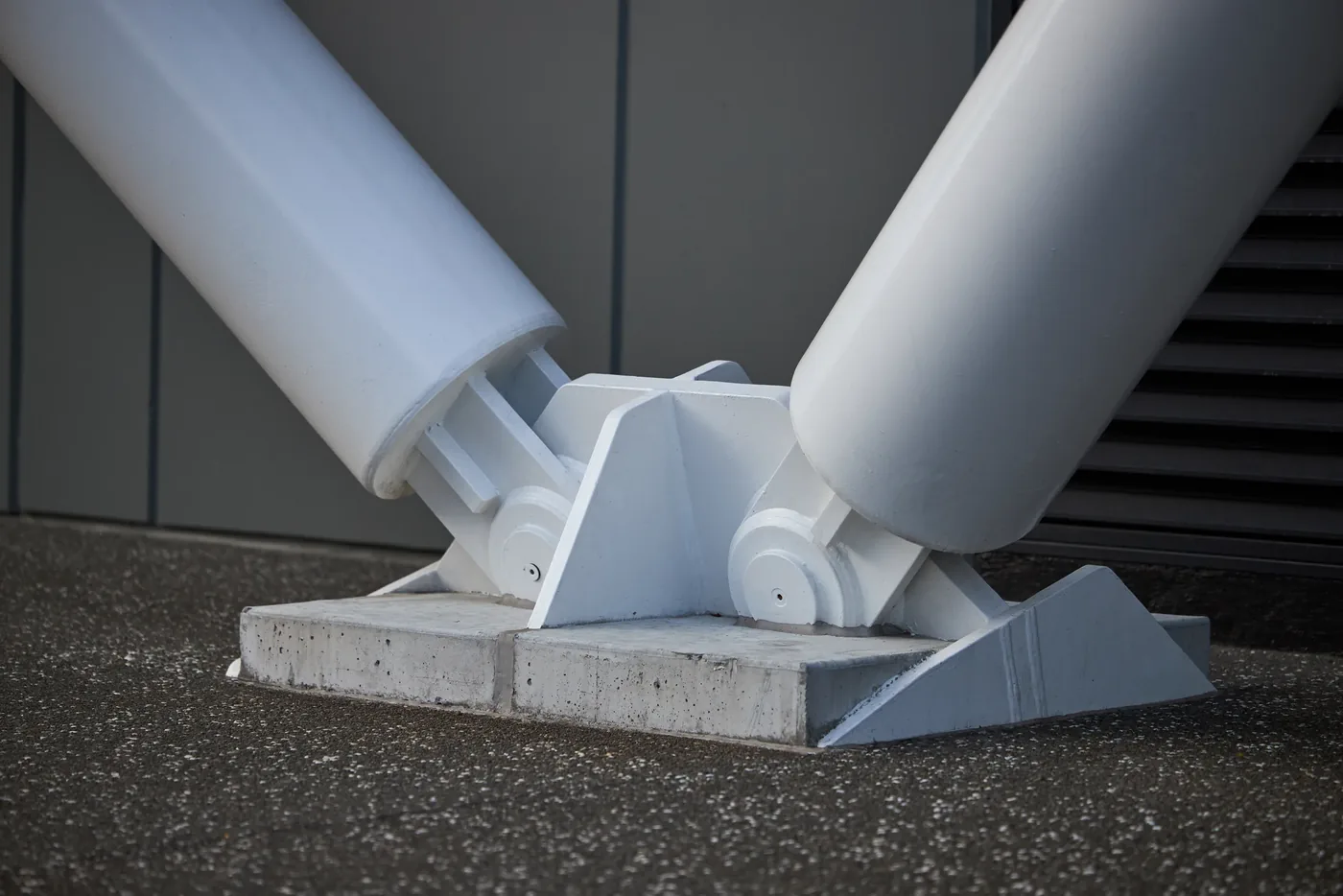 Structural steel struts meeting at a pinned base connection